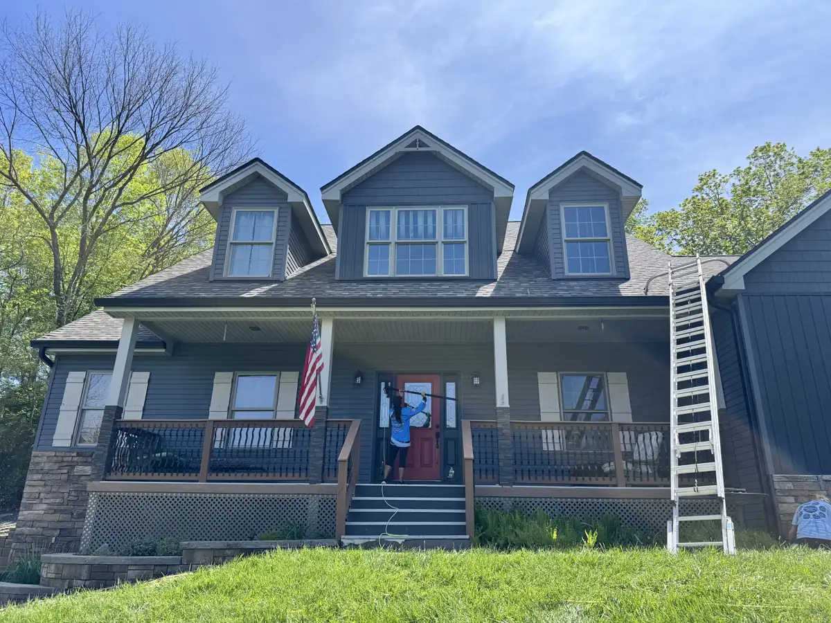 Skyline crew washing windows & entry door on a craftsman home