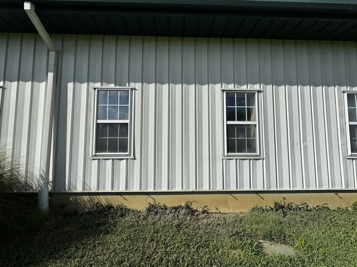 Metal building siding restored after commercial rust removal by Skyline